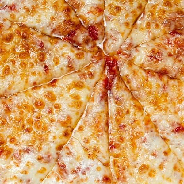 Close-up of a freshly baked, sliced cheese pizza with melted, bubbly mozzarella and red sauce.